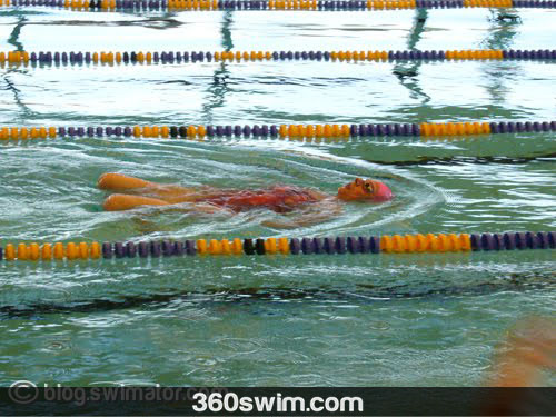 Practicing breaststroke kick on the back to check for flaws.