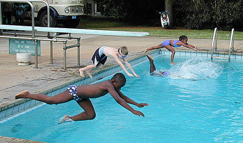 Kids diving belly first by IITA Image Library