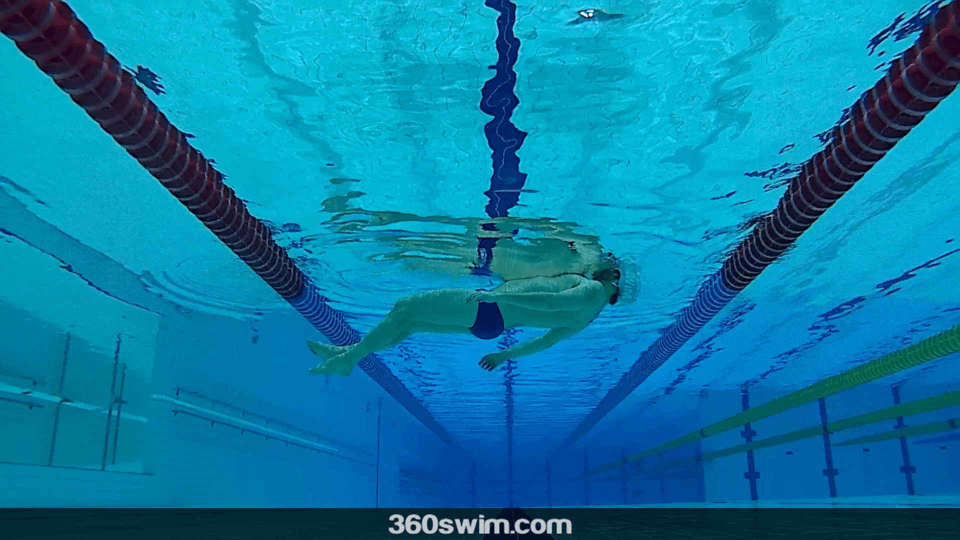 Floating on your back is one of the safest ways to rest and stay calm in open water. A man floating relaxed on his back in the pool
